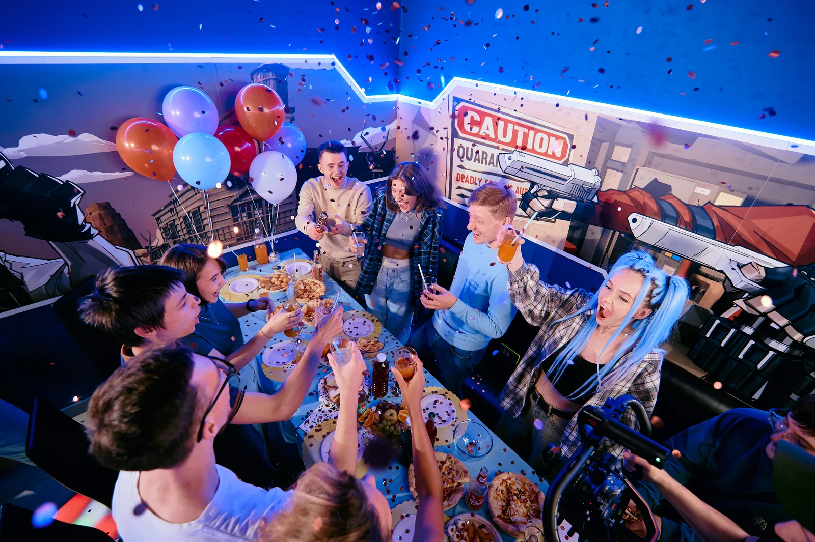 A group with confetti raising a toast at a party table in the lounge