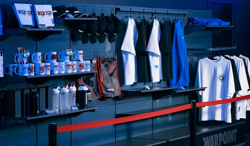 A WARPOINT branded merch display in the venue