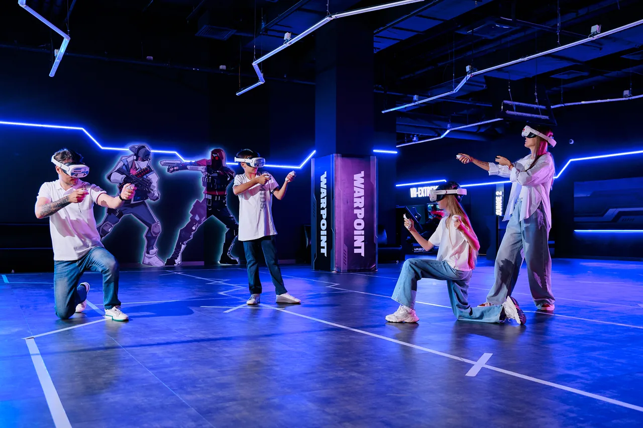 Teenagers in VR headsets playing on the blue floor of a WARPOINT arena