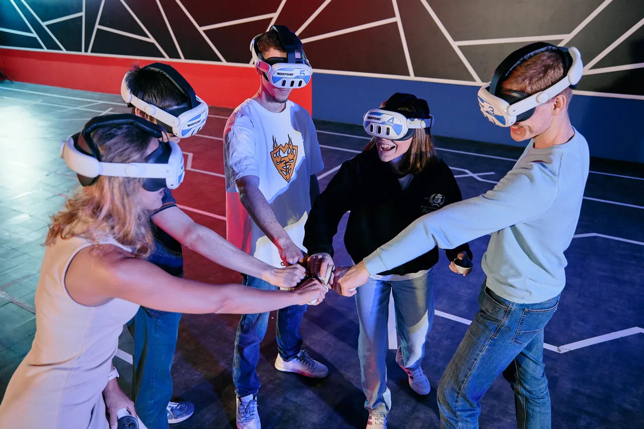 A team stacking hands in a circle before the game